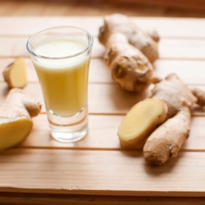 fresh organic healthy ginger shot juice and root