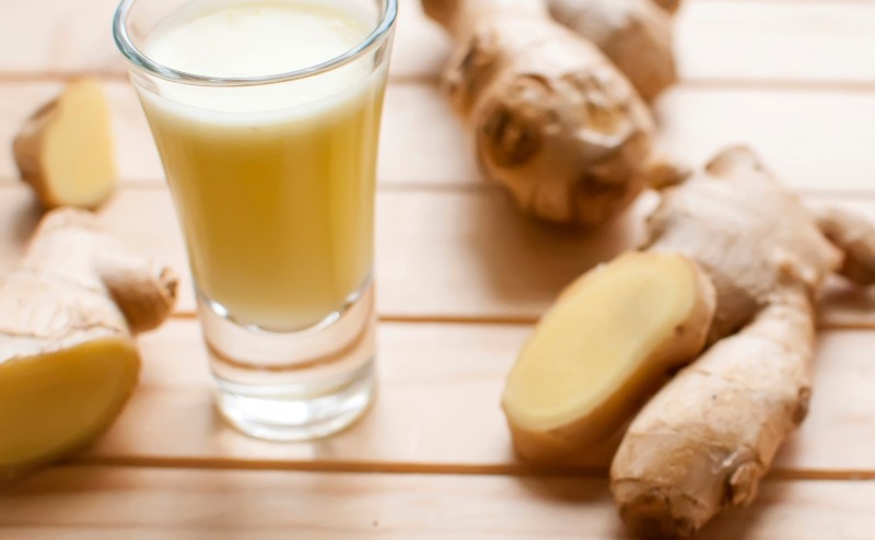 fresh organic healthy ginger shot juice and root